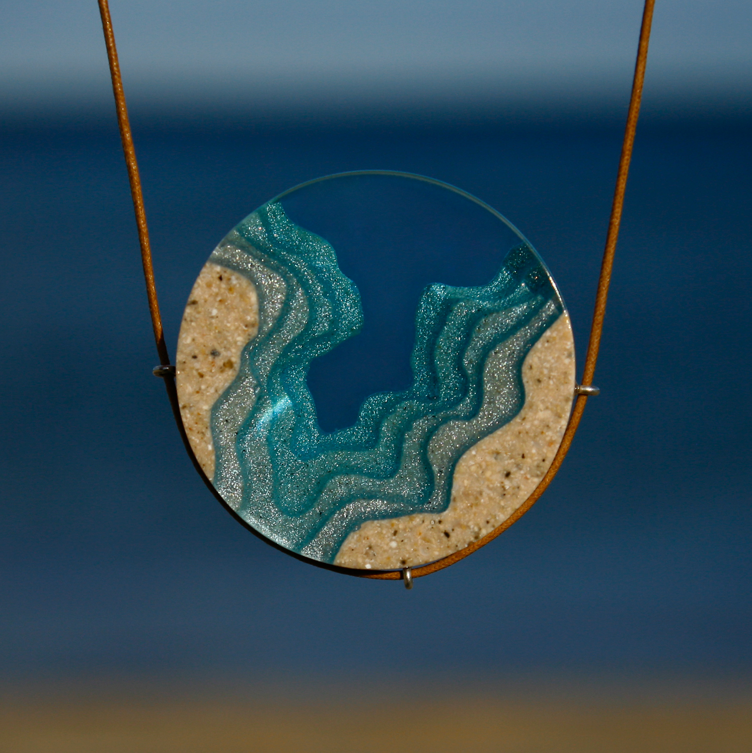 Abyss beach necklace on blue background