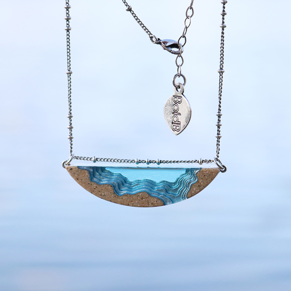 Longshore handmade beach sand and resin necklace on beach